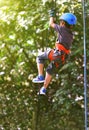 One little boy child climbing tree on ropes used safety equipment at park . Royalty Free Stock Photo