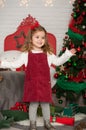 One little Caucasian cute girl smiling with present box in the festive New year studio room Royalty Free Stock Photo