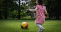 A little girl with a soccer ball on the lawn. Royalty Free Stock Photo