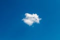 One little cloud on blue sky. Small, fluffy and lonely cloud for background with copy space Royalty Free Stock Photo