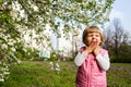 One little girl yawning near tree