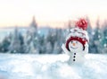 One little snowmen in caps on snow in the winter. Background with a funny snowman. Christmas card Royalty Free Stock Photo