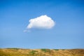 One lonely cloud in blue sky.