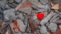 One lonely heart against background of broken concrete fragments. Unhappy love relationships. Infidelity and betrayal