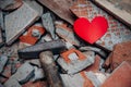 One lonely heart of shards next to hammer.. Concept of broken love. Unhappy relationships. Difficult period in family