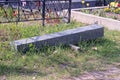 One long gray granite pillar for the monument lies on the green grass