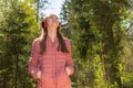 One lovely slim fit thin teen girl enjoying, listening to music in the forest while walking spring day forest or park Royalty Free Stock Photo