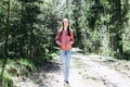 One lovely slim fit thin teen girl enjoying, listening to music in the forest while walking spring day forest or park Royalty Free Stock Photo