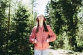 One lovely slim fit thin teen girl enjoying, listening to music in the forest while walking spring day forest or park Royalty Free Stock Photo