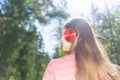 One lovely slim fit thin teen girl enjoying, listening to music in the forest while walking spring day forest or park Royalty Free Stock Photo