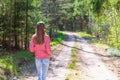 One lovely slim fit thin teen girl enjoying, listening to music in the forest while walking spring day forest or park Royalty Free Stock Photo