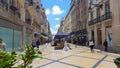 One of the main streets of lisbon, a normal day with street artists, tourists and people in their day and daily tasks