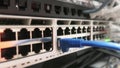 One male IT engineer working in a data center with rows of server racks and super computers.