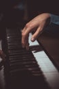 One male hand on the piano. The palm lies on the keys and plays the keyboard instrument in the music school. student learns to Royalty Free Stock Photo