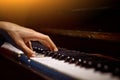 One male hand on the piano. The palm lies on the keys and plays the keyboard instrument in the music school. student learns to Royalty Free Stock Photo