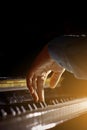 One male hand on the piano. The palm lies on the keys and plays the keyboard instrument in the music school. student learns to Royalty Free Stock Photo