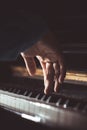 One male hand on the piano. The palm lies on the keys and plays the keyboard instrument in the music school. student learns to