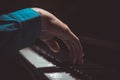 One male hand on the piano. The palm lies on the keys and plays the keyboard instrument in the music school. student learns to Royalty Free Stock Photo