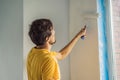 One male house painter worker painting and priming wall with painting roller. DIY Royalty Free Stock Photo
