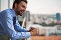 One male worker drinking coffee on office balcony Royalty Free Stock Photo