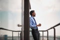 One male worker drinking coffee on office balcony Royalty Free Stock Photo