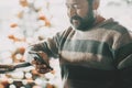 One man doing phone call inside a commercial mall center in christmas december season with holiday tree decorated in backgorund. Royalty Free Stock Photo