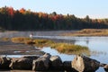 One man in a green canoe with yellow paddle, on Eel River, New Brunswick, Canada, in early morning. Royalty Free Stock Photo