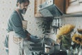 One man at home washing dishes and cooking lunch alone in house job leisure activity. Alternative male lifestyle and single daily Royalty Free Stock Photo