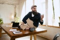 One man, office clerk wearing business style clothes having fun, doing yoga on wooden table in modern office at work