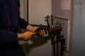 One man repairs filter of gas boiler