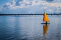 One man sailboat - single yellow sail on turquoise water - matching sky - Pumicestone Channel narrow waterway between Bribie