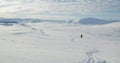 One man snow shoe hiking at the vast snow expanse at snow covered mountains