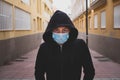 One man teenager looking seriously at the camera wearing medical and surgical mask on the face to prevent covid-19 or coronavirus Royalty Free Stock Photo