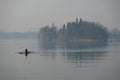 One man training rowing on the lake Royalty Free Stock Photo