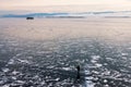 One man walking across frozen lake Royalty Free Stock Photo