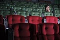 One man watches cinema alone, separate from other audiences at empty theaters. Royalty Free Stock Photo