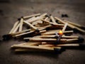 One Matchstick burning on top of many exhausted matchsticks
