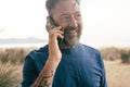 One mature man do phone call outdoor having fun and smiling. Modern people using cellphone roaming connection technology outside Royalty Free Stock Photo