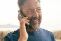 One mature man do phone call outdoor having fun and smiling. Modern people using cellphone roaming connection technology outside Royalty Free Stock Photo