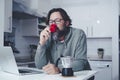 One mature man at home having a coffe in the morning in the kitchen. Single people lifestyle. Modern adult male drinking espresso