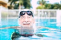 One mature man or senior at the swimming pool looking at the camera smiling and having fun alone - healthy and fitness lifestyle Royalty Free Stock Photo