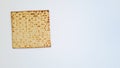 One matza bread, symbol of Passover on a white background