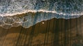 One men stay on the beach. Wave and shadow reflection from palms. Dark Royalty Free Stock Photo