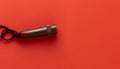 One metal whistle with cord on red background, top view. Space for text Royalty Free Stock Photo
