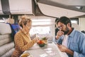 One middle age couple enjoy time playing cards together inside travel home camper van. People enjoying time on vacation smiling Royalty Free Stock Photo
