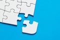 One missing puzzle piece on blue background with copy space. Connection or separation concept Royalty Free Stock Photo