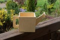 One mock toy wooden watering can made of plywood on a brown table