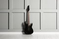 One modern electric guitar near grey wall Royalty Free Stock Photo