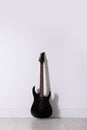 One modern electric guitar near white wall Royalty Free Stock Photo