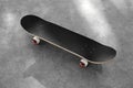 One modern skateboard with black griptape on ground outdoors Royalty Free Stock Photo